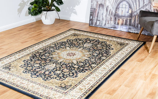 Navy traditional area rug with cream border and central floral medallion
