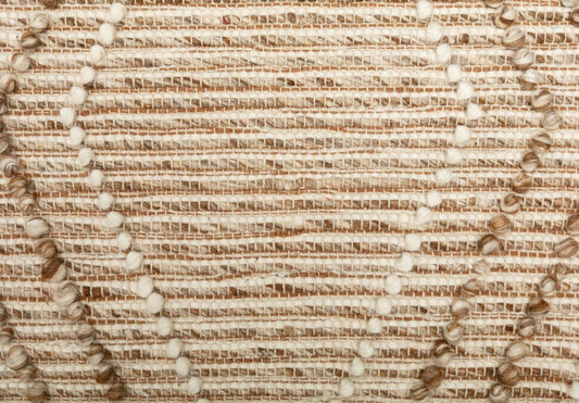 Beige wool area rug texture close-up with woven lines and tufted details