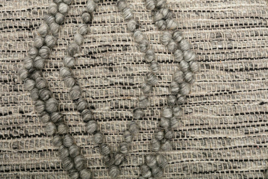 Grey wool modern rug with raised looped pattern and grid texture