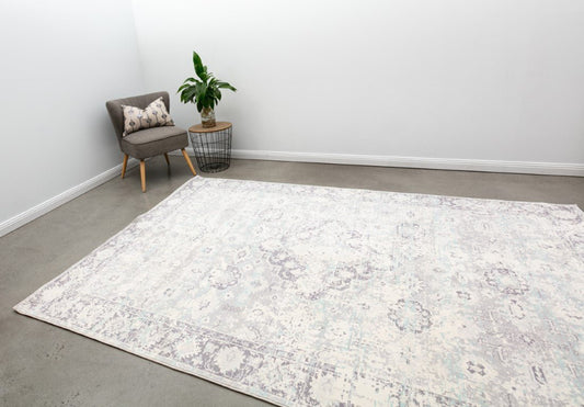 Contemporary area rug with light ivory field and pale blue geometric pattern, border medallions