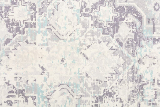 Contemporary rug pattern close-up in ivory with pale blue and gray geometric motifs