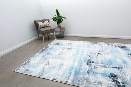 Contemporary area rug featuring wide blue and cream abstract brushstroke design.