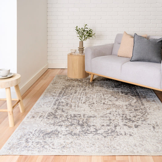 Gray and white distressed area rug with worn-look texture across surface