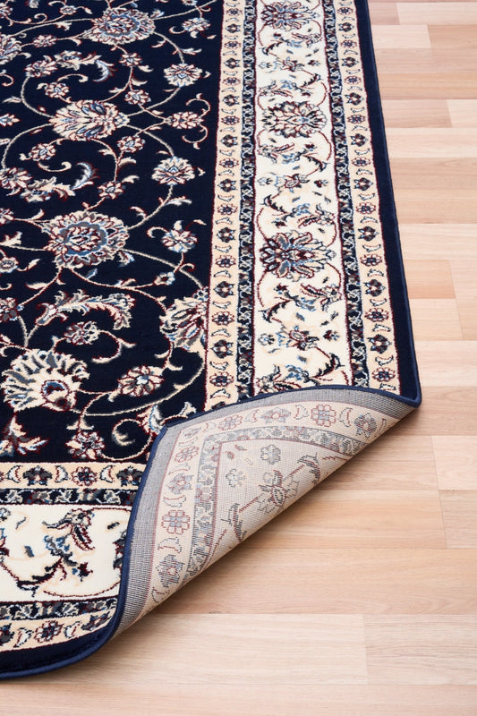 BALUCHI navy area rug showing folded edge and floral stripe border