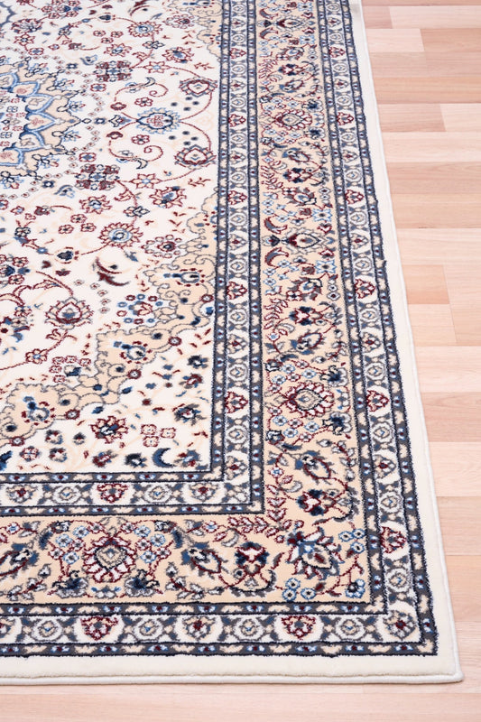 Ivory rug with central floral medallion and blue border at corner