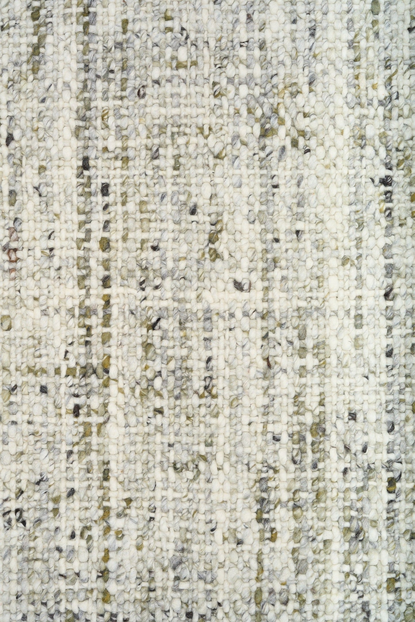 Ivory and light green speckled textured rug surface close-up