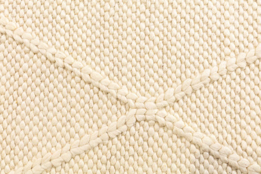 Cream wool rug textured loop pile close-up
