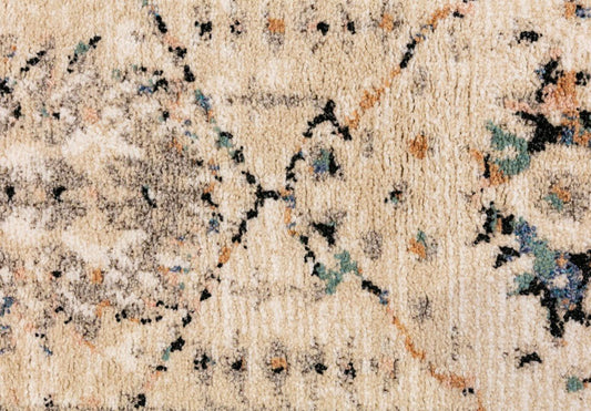 Close-up of ivory-beige rug pile with black and multicolor distressed speckling