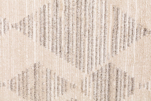 Ivory-beige rug close-up showing distressed diamond lines texture
