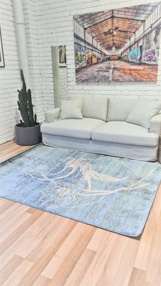 Blue modern area rug with abstract swirl design, flat woven look