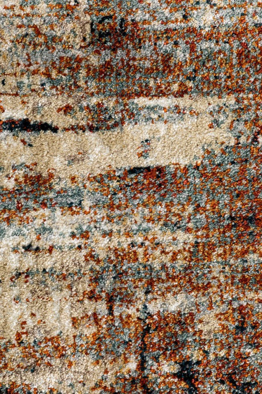 Multicolor abstract rug surface with speckled navy, orange, and light beige fibers