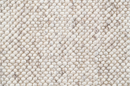 Cream and almond textured rug with dense looped weave pattern