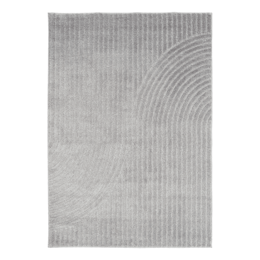 Light grey Turkish rug with wavy concentric pattern on flat surface