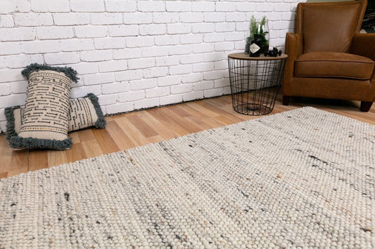 Speckled wool carpet rug in light grey/cream, wide view