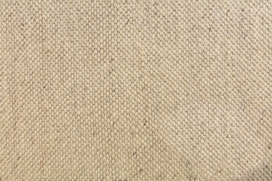 Light beige wool rug with tight woven grid texture