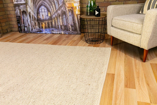 Beige wool rug with textured surface and visible corner edge