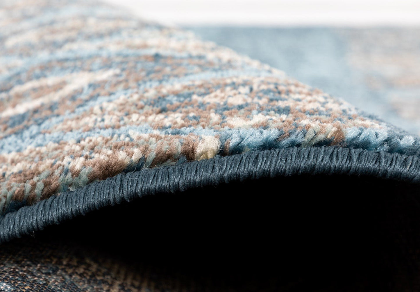 Blue rug corner with dark serged edge and mottled woven pile texture | Raffia Rug 2367 Blue colour Modern Abstract Floor Rug - Rugs Point Australia
