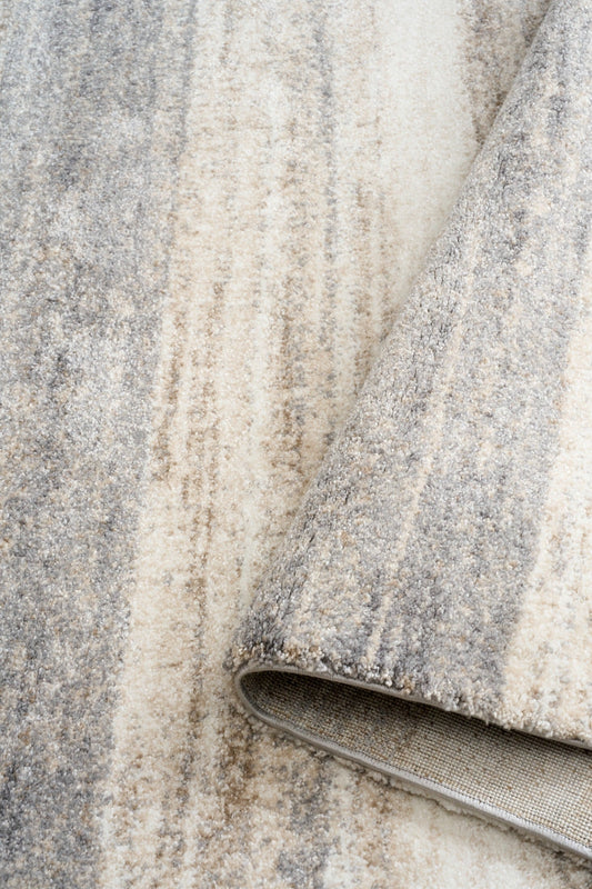 Bone grey rug fabric close-up with bound edge and fine mottled texture