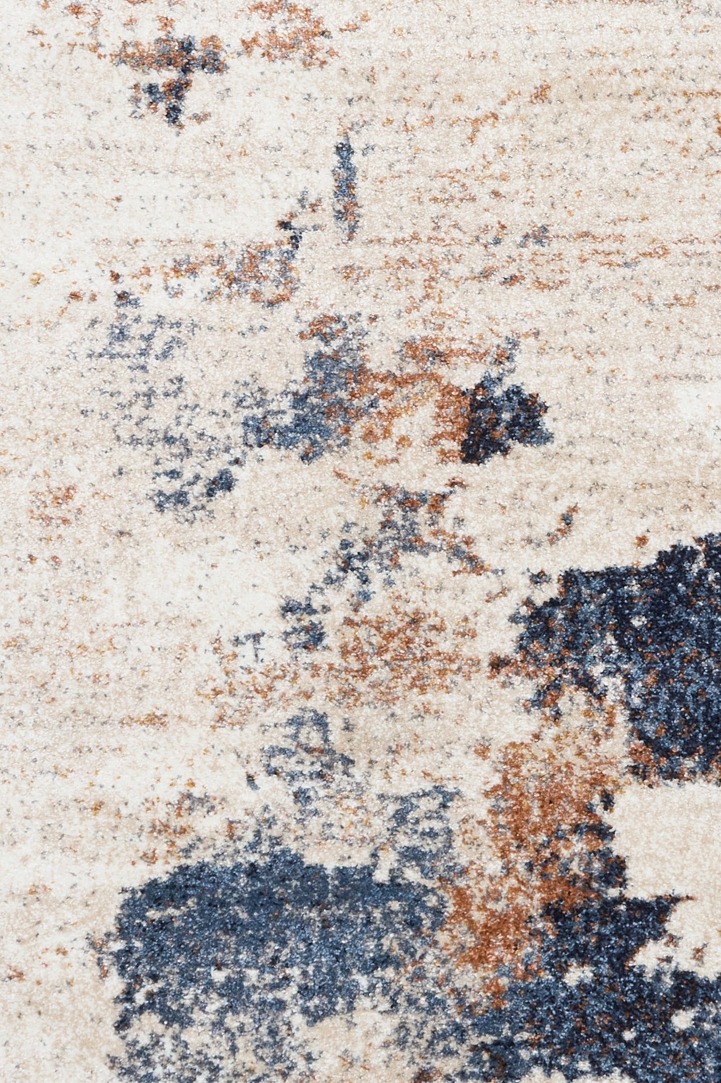 Surface close-up of abstract rug showing cream, blue, and rust mottled texture