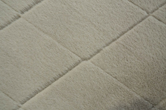 Silver shag rug close-up with soft plush pile and subtle diamond texture