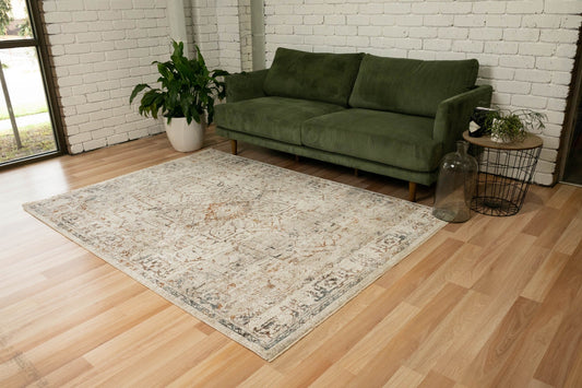 Multi-color distressed floor rug with ornate geometric medallion, light beige base