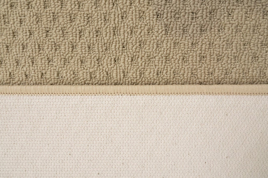 Beige textured mat with tight loop pile and visible border edge