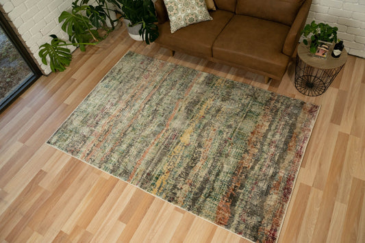 Zarita area rug with distressed multicolor pattern in muted green, red, beige