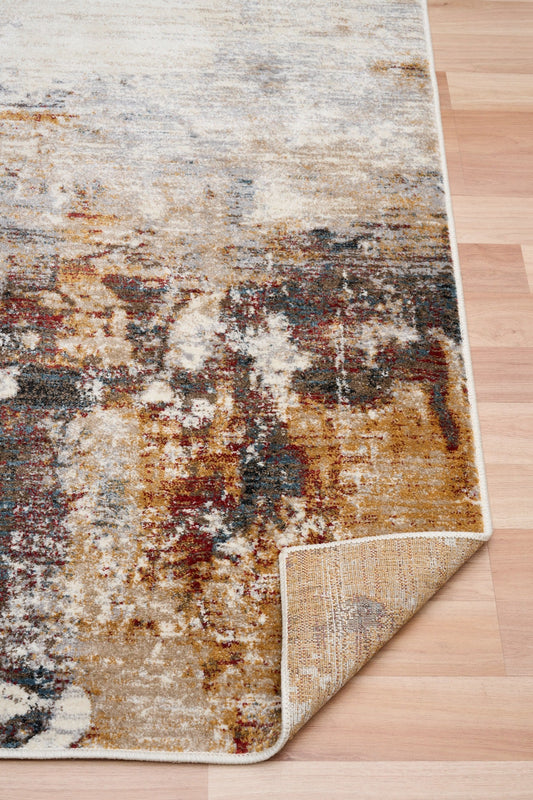 Corner view of abstract area rug showing stitched border and layered texture