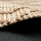 Beige wool rug corner with braided edge and dark underside backing