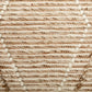 Beige wool area rug texture close-up with woven lines and tufted details