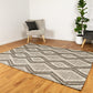 Modern charcoal and cream wool rug with zigzag lines; styled in a living room.