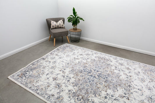 Contemporary area rug with distressed floral pattern in white, gray, and blue