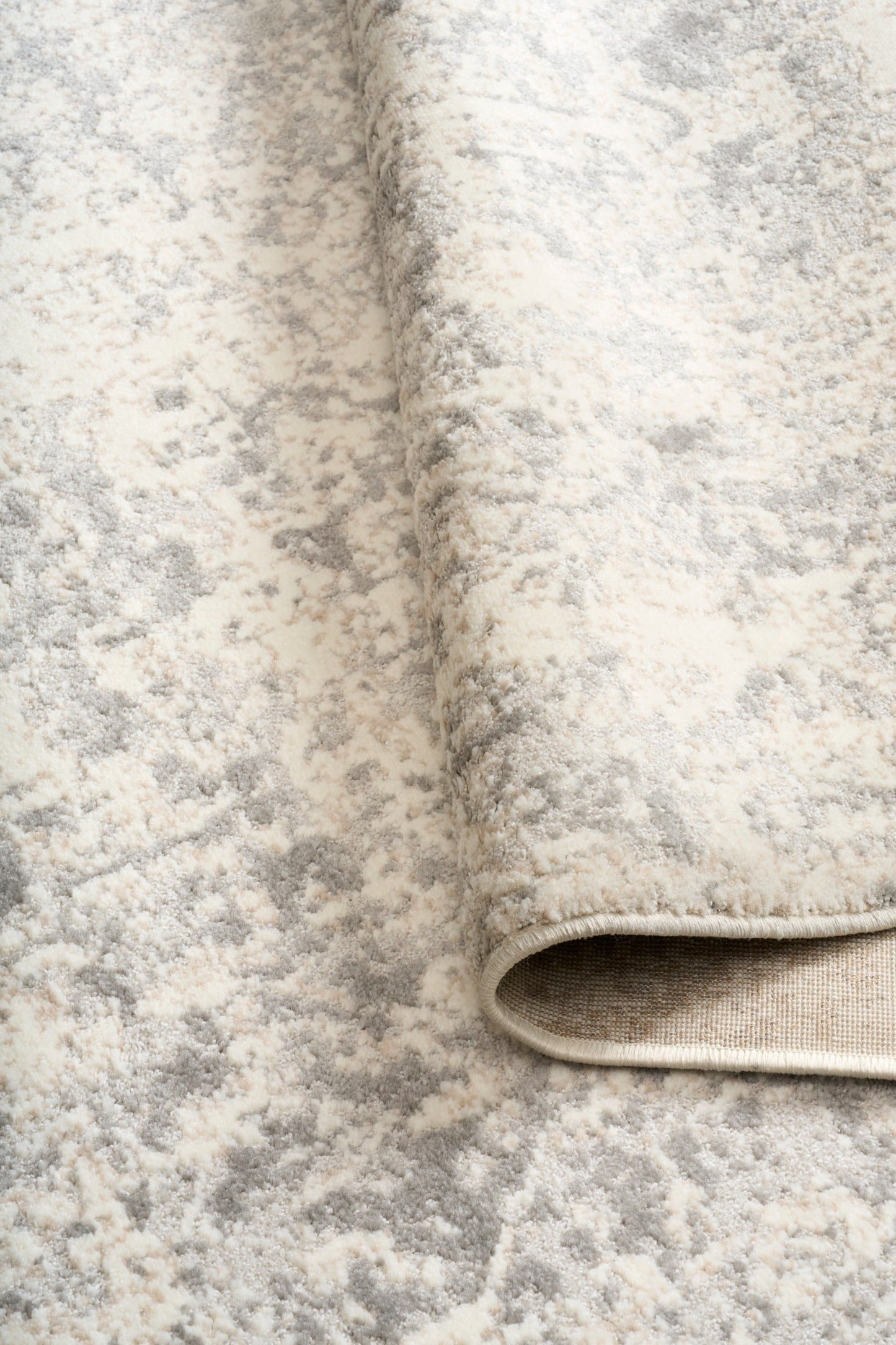 ARUBA 6908 area rug close-up of low-pile distressed abstract light beige and gray texture