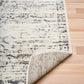 Close-up of light gray distressed abstract area rug pattern and bound edge