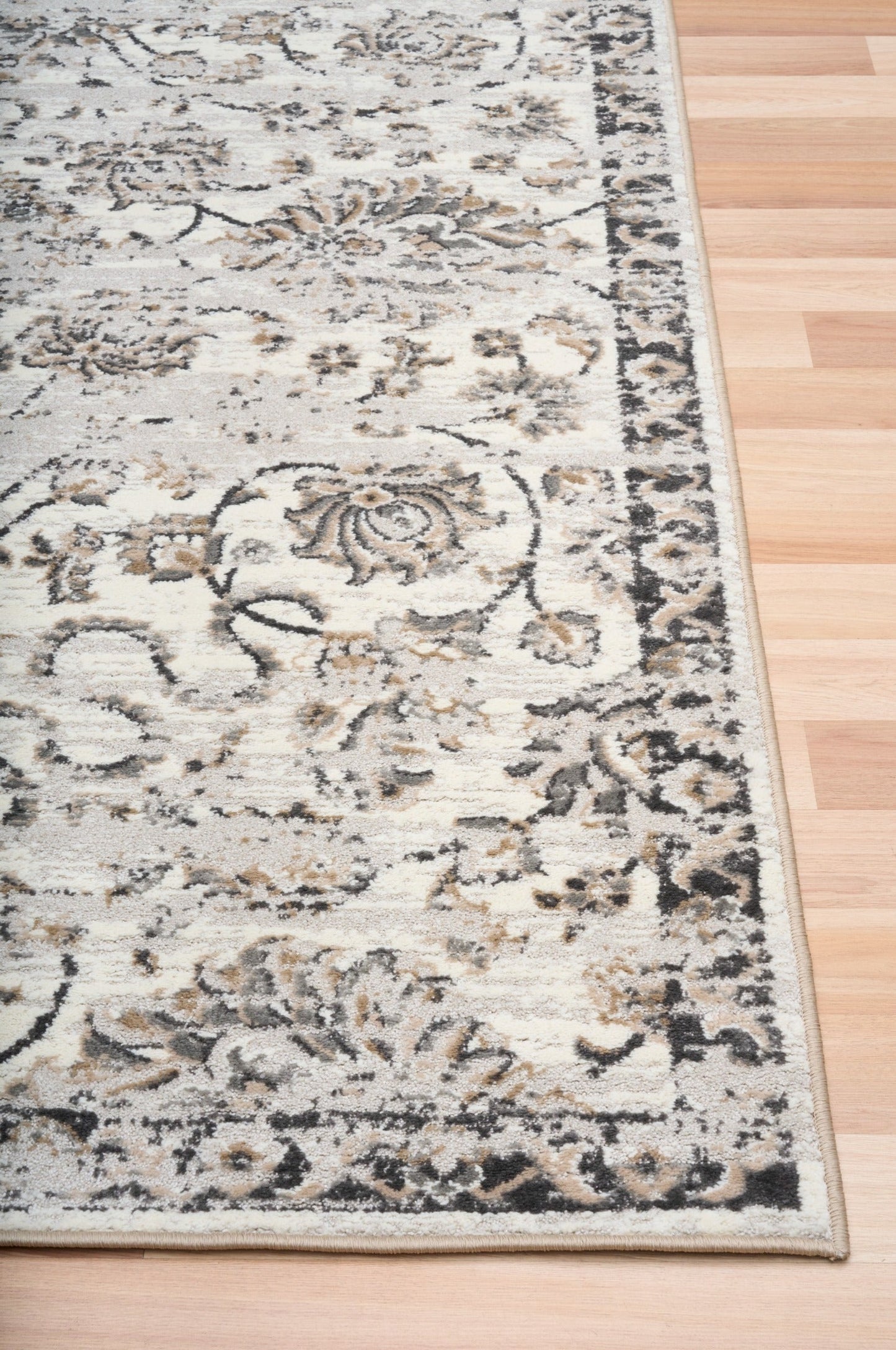 Grey and cream damask area rug with decorative border and distressed ornamental details