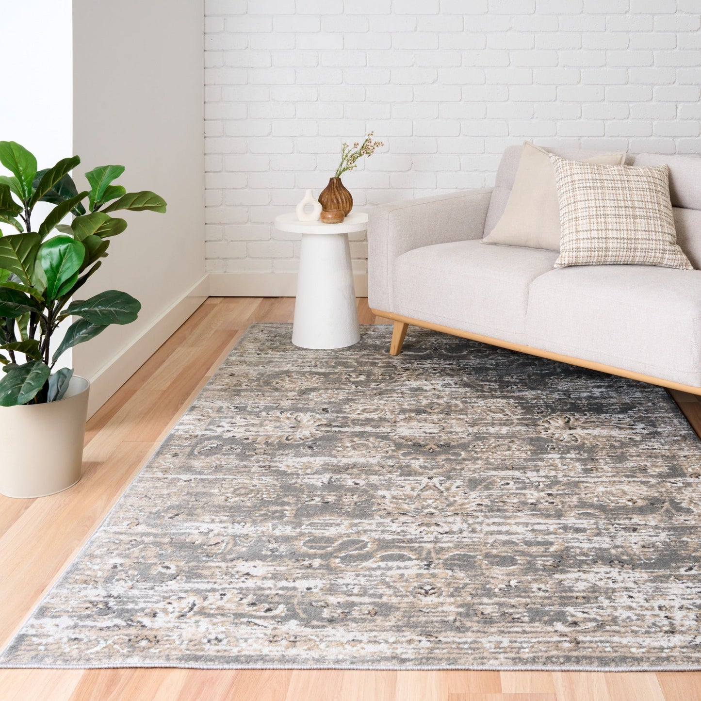 Distressed light gray area rug with cream abstract pattern, short pile
