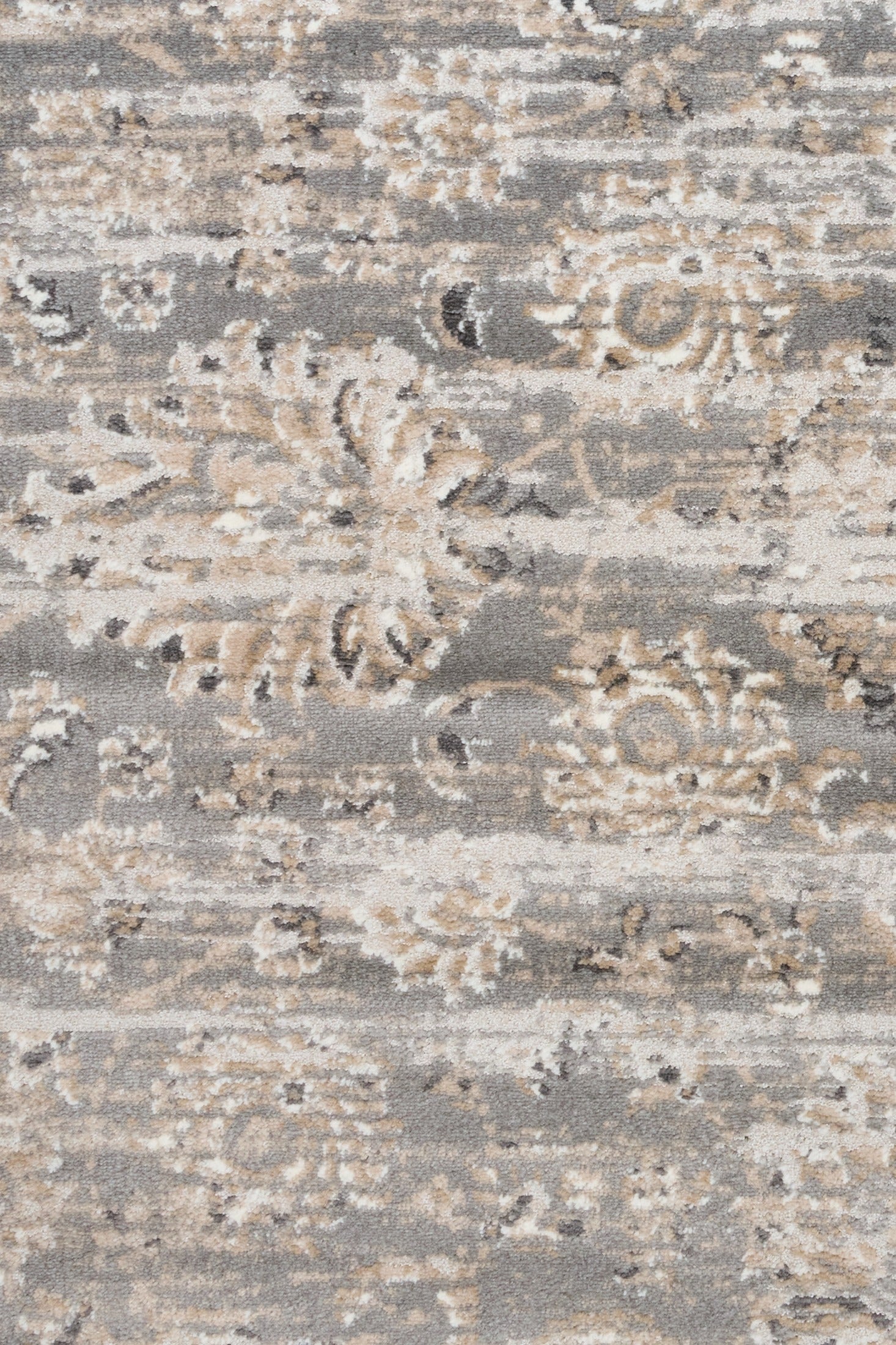 Close-up of light gray rug with cream abstract distressing and textured weave