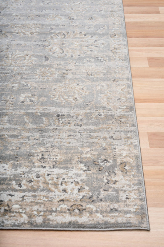 Rectangular gray and beige area rug with faded distressed pattern and flat weave.