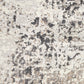 Abstract gray and white rug surface with mottled speckled texture
