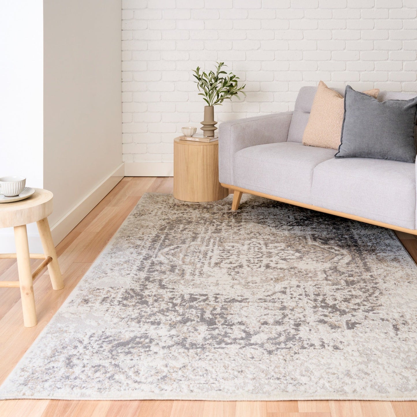 Gray and white distressed area rug with worn-look texture across surface