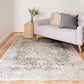 Light gray and white area rug with abstract distressed pattern