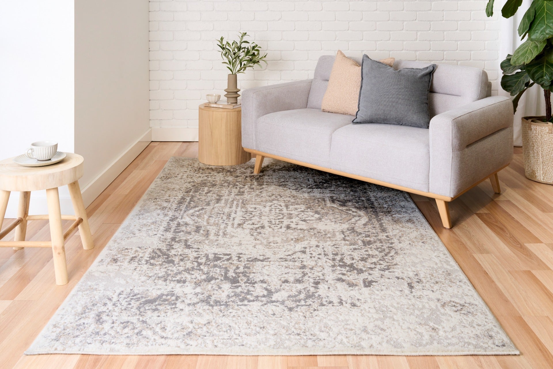 Light gray and white area rug with abstract distressed pattern