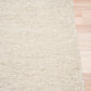 Cream woven area rug corner with textured edge