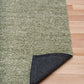 Olive green area rug with dark backing visible at folded corner
