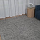 Grey speckled area rug with dense textured pile and even surface