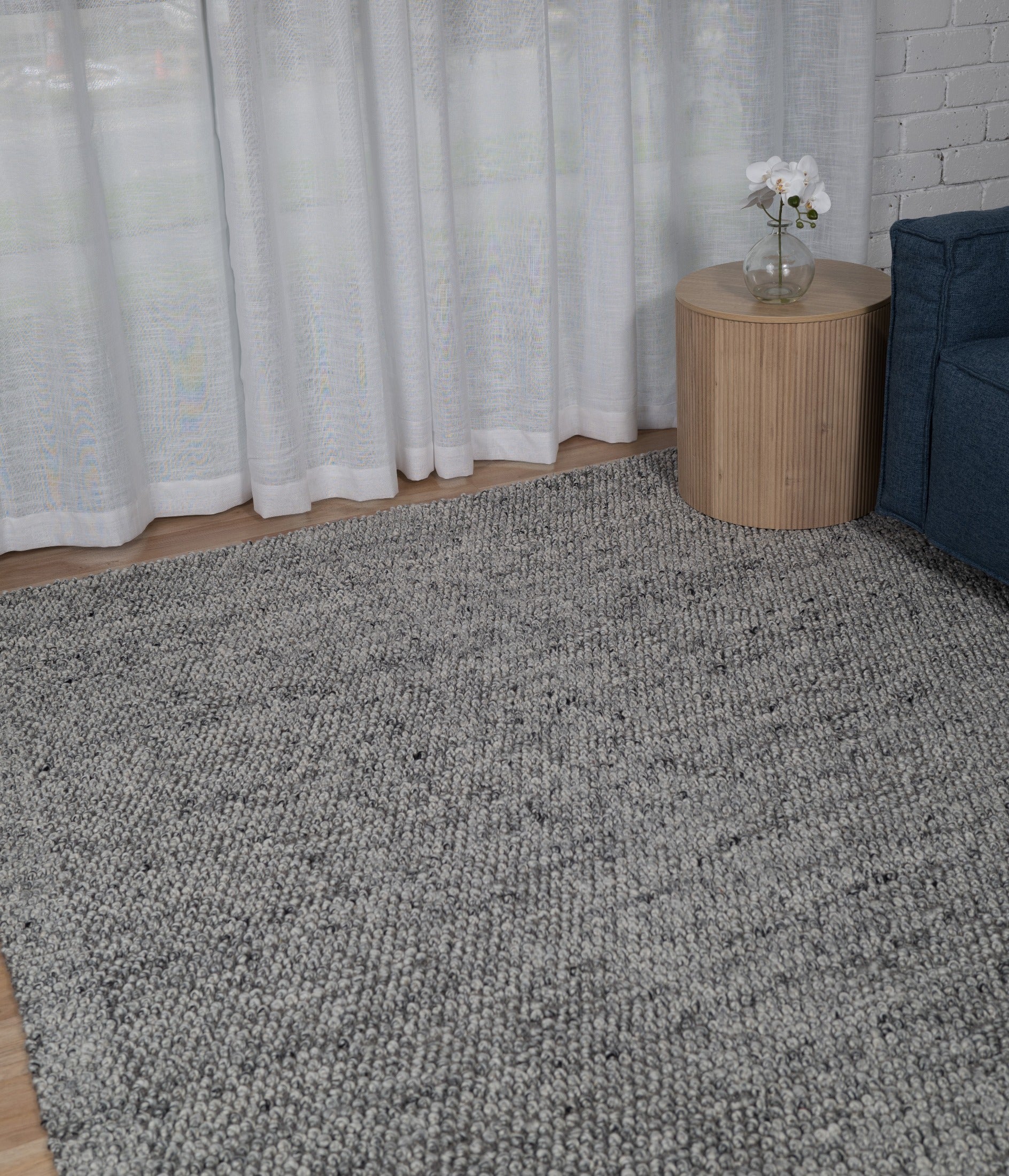 Grey speckled area rug with dense textured pile and even surface