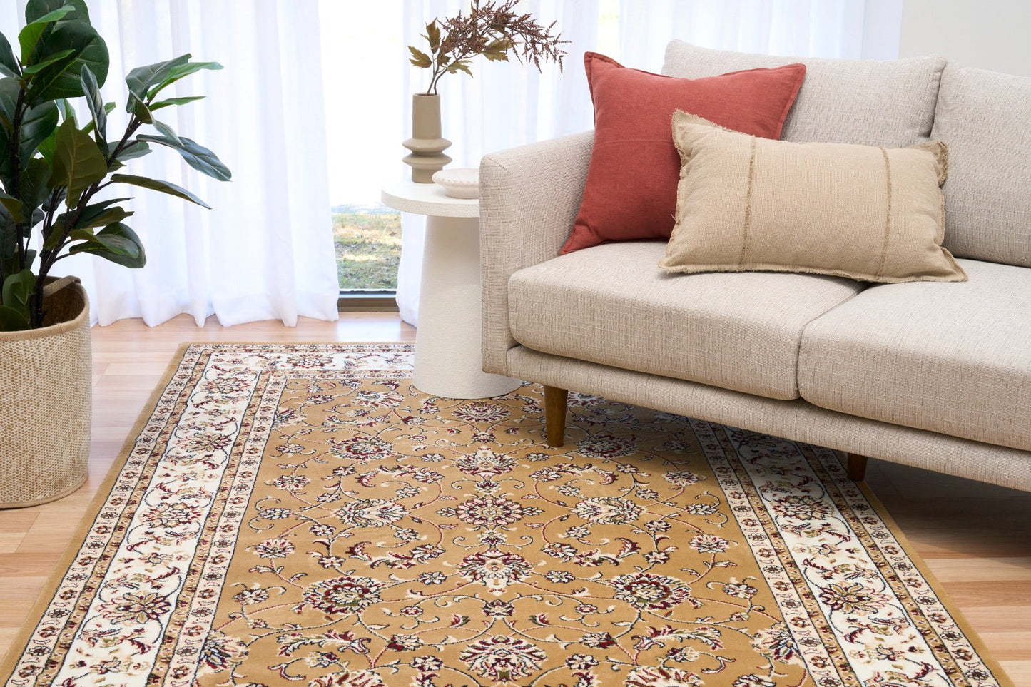 Berber-style area rug with tan field, floral vines, and cream red border stripes