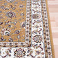 Berber-style area rug corner detail, tan field with floral medallions and cream frame