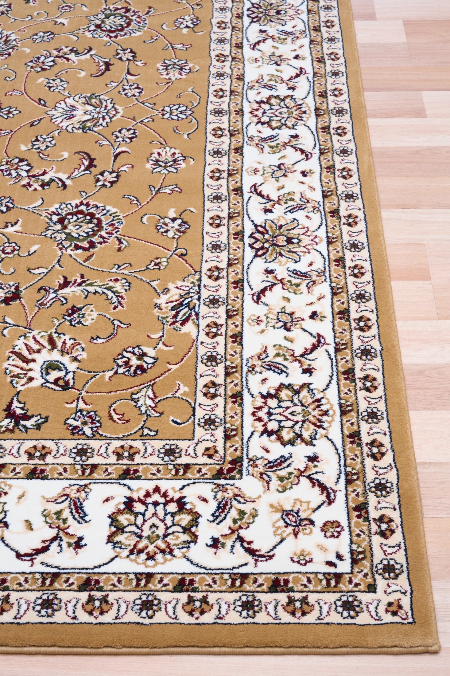 Berber-style area rug corner detail, tan field with floral medallions and cream frame