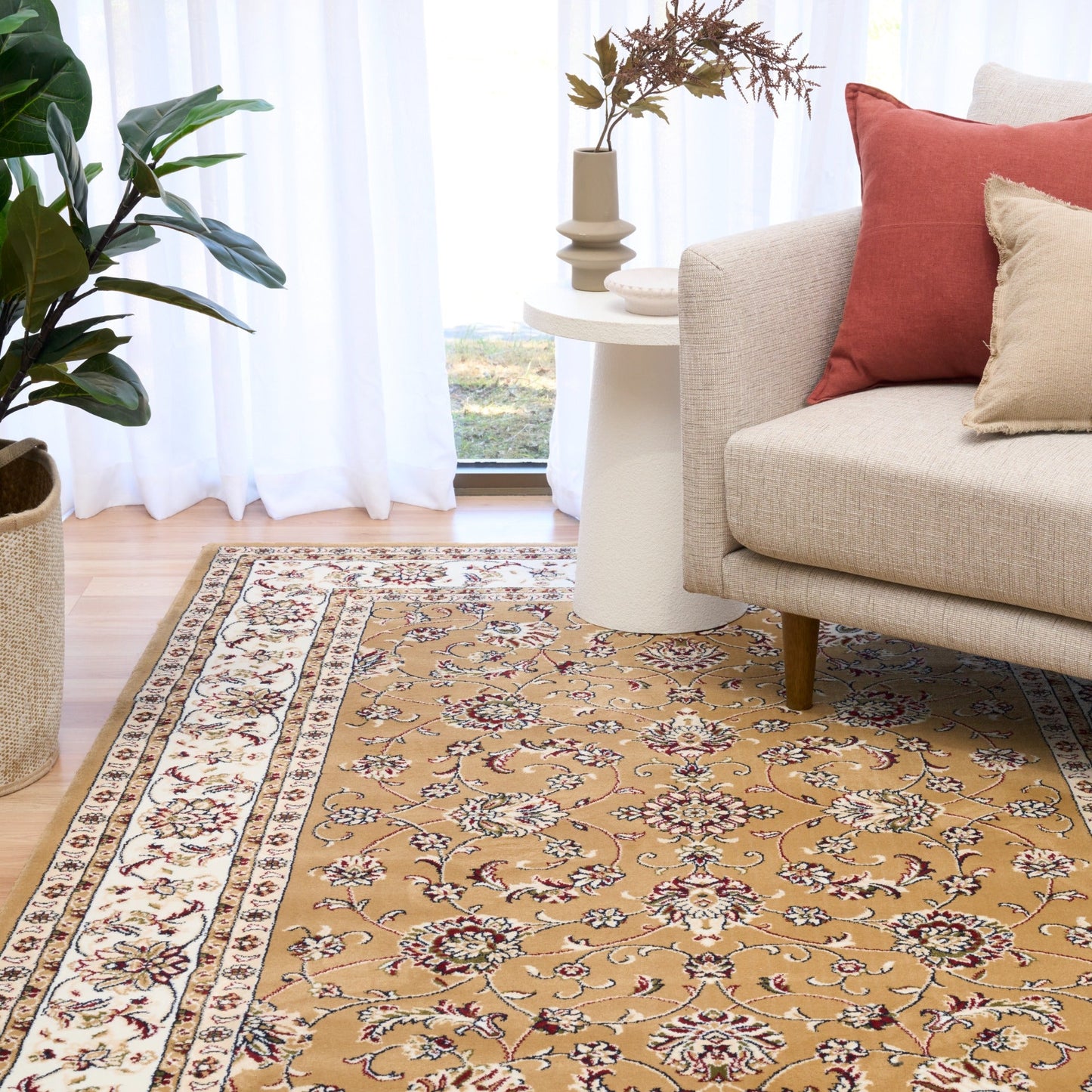 Berber-style area rug with tan floral pattern, cream border stripes, and medallion center
